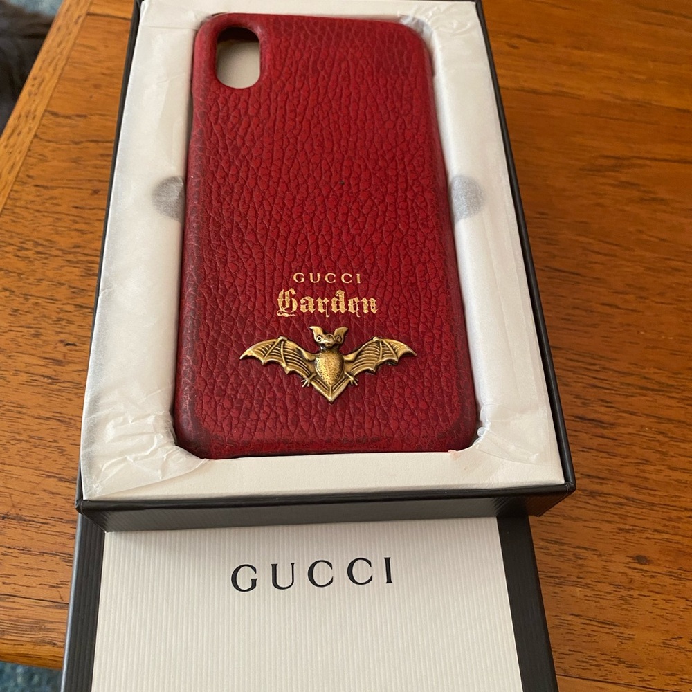 Gucci burgundy gently used Leather Phone Case with Gold Bat Accent. Unisex